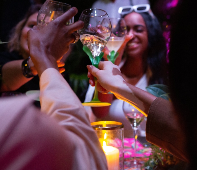 Winnie Harlow and Emmanuel Perrotin engage the conversation between guests during the banquet